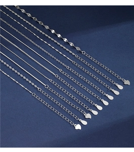 Macro shot showing ten different styles of 925 silver necklace chains with heart tags