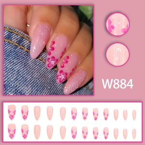 Faux ongles fleurs de cerisier rose avec dégradé pailleté et pois de forme amande
