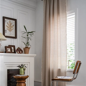 Close-up of bohemian linen blend curtain showing natural beige fabric texture and minimalist edge