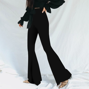Side view of high-waisted black flare pants showing the slim fit silhouette and wide leg