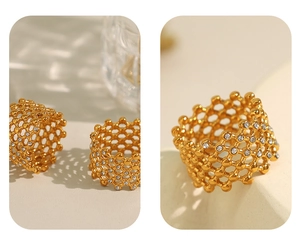 Detailed close-up of golden honeycomb hollow design ring with sparkling crystal inlay