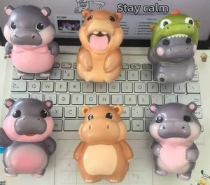 Set of six colorful slow-rising hippo squeeze toys on a computer keyboard background