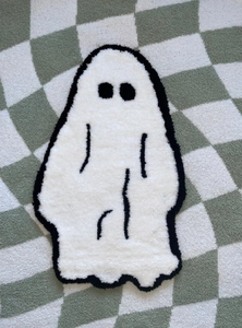 Macro detail of ghost tufted rug showing soft texture on checkered background