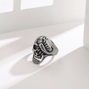 Punk style 316L stainless steel skull ring with scorpion side engraving on white surface