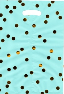 Detail of mint green plastic gift bag with metallic gold polka dots and handle
