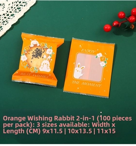 Close-up of orange frosted heat-seal mooncake bags with white rabbit and floral illustrations