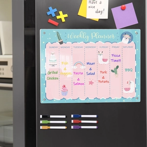 Close-up of magnetic acrylic weekly planner with colored markers on a black fridge