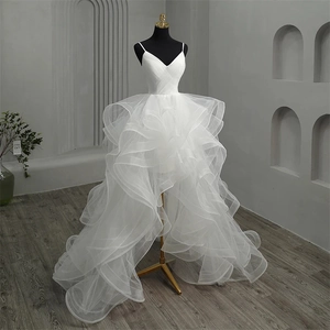 Elegant high-low white bridal gown with deep V-neck and tiered ruffle tulle skirt