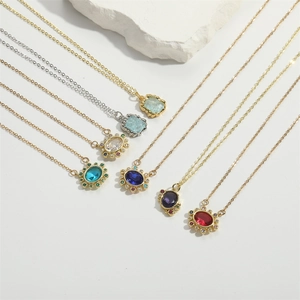 Close-up of elegant oval gemstone pendants in multiple colors with gold and silver chains