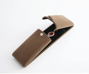 Detailed view of brown velvet jewelry box for necklaces with secure metal snap button