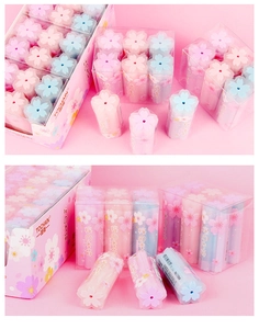 Macro shot of cherry blossom shaped erasers in pastel pink and blue with jelly texture