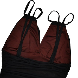 Detail of burgundy V-neck bodice with black ruched straps and backless design for evening dress