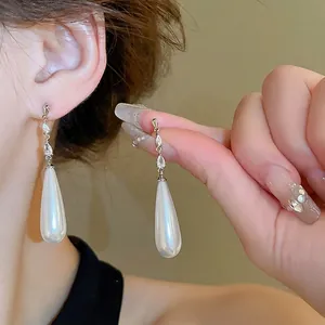 Elegant teardrop pearl earrings with marquise cut zircons and silver needle hook