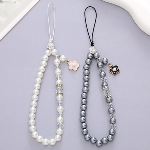Elegant beaded mobile phone strap with pearl beads and floral pendants in black and white