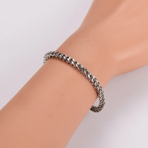 Minimalist silver stainless steel curb chain bracelet with a polished industrial finish