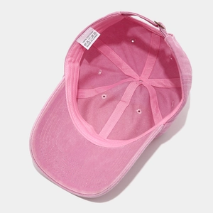 Detail view of pink cotton baseball cap interior with 100% cotton label and quality stitching