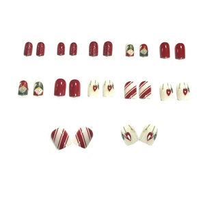 Christmas press-on nails set with Santa Claus, glitter red, and candy cane stripe designs