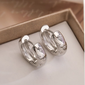 Silver star earrings with cubic zirconia stones in a premium jewelry gift box