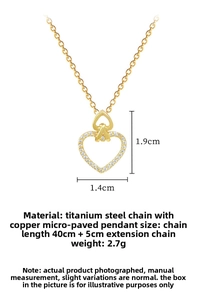 Macro detail of gold double heart pendant necklace with shimmering zircon pavé inlay
