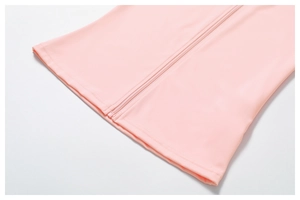Detail of pink zip-up sports jacket showing high-stretch fabric and precision stitching