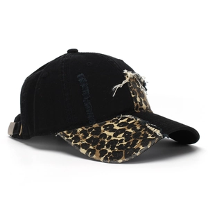 Close-up of distressed baseball cap with leopard print splicing and adjustable metal buckle
