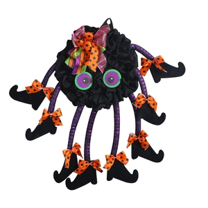 Whimsical Halloween spider wreath with purple striped legs and festive ribbon decor