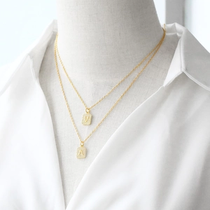Gold layered necklace with cubic zirconia square letter pendants V and A for women