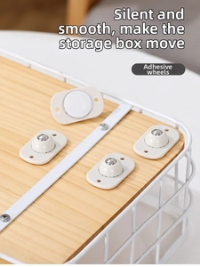 Close-up of adhesive ball caster wheels installed on a wooden storage box base