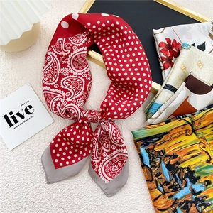 Red paisley and white polka dot silk scarf with oil painting patterns on white surface