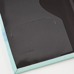 Detail of the mint green passport cover with a transparent PVC card slot and inner lining