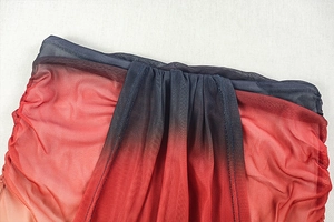 Close-up of red and black gradient mesh fabric with elegant pleated texture detail