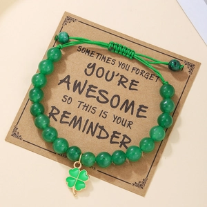 Detail of green beaded clover bracelet with adjustable cord and inspirational gift card