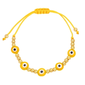 Detail of bohemian yellow cord bracelet with evil eye beads and adjustable golden closure