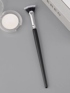 Macro shot of fan makeup brush with soft black and white gradient synthetic bristles