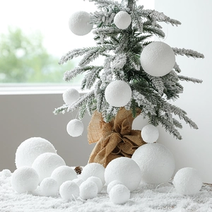 White foam snowballs in various sizes for Christmas tree decor and winter party atmosphere