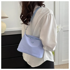Chic light blue oxford shoulder bag with matte finish and secure metal zipper detail