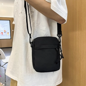 Minimalist black nylon crossbody bag for men with adjustable strap and dual zipper pockets