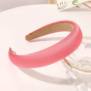 Detailed close-up of a thick pink satin sponge headband with anti-slip inner lining