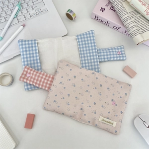 Floral and plaid fabric notebook covers in a minimalist aesthetic desktop stationery scene
