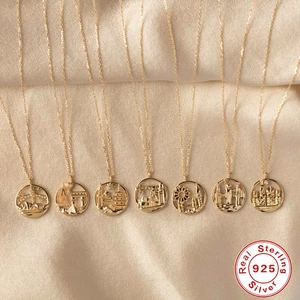 S925 sterling silver necklaces featuring gold world city landmark pendants on silk background