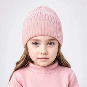 Close-up of pink ribbed knit baby beanie hat with warm ear protection for children