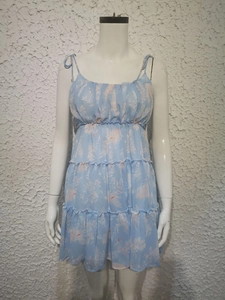 Detail of light blue floral sundress with tiered ruffle hem and high waist smocking design