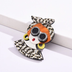 Artistic acrylic portrait brooch featuring a checkered headscarf and round glasses