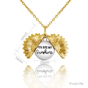 Detail of opening sunflower locket necklace with You Are My Sunshine engraving