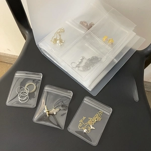Detailed view of clear PVC jewelry storage bags with airtight seals on a seat