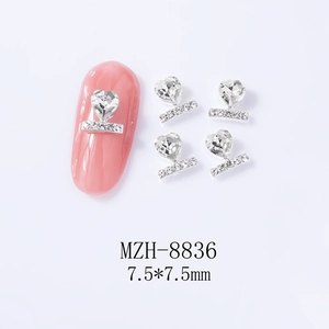 Macro detail of 7.5mm silver heart nail charms with rhinestones for manicure art