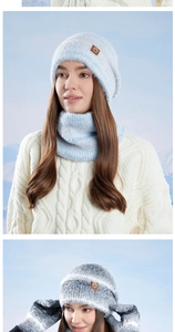 Close-up of winter knitted set including hat, scarf, and gloves in snowy outdoor setting