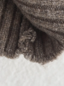 Close-up of the brown ribbed knit texture and cuff detail on this elegant women cardigan