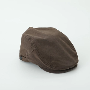 Detail view of the retro brown cotton fabric and side button on this boy's flat cap