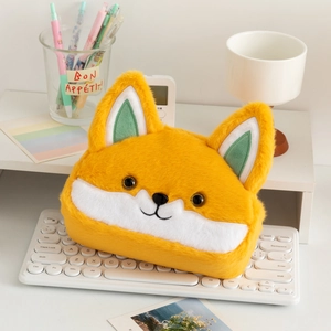 Macro shot of cute plush fox stationery bag on a desk with a white keyboard